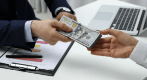 handing over money.