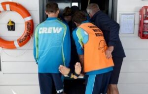 Cruise tour staff helping injured person in an emergency drill