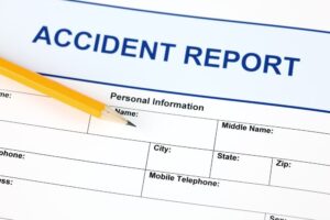 Accident report application form accompanied by a pencil.