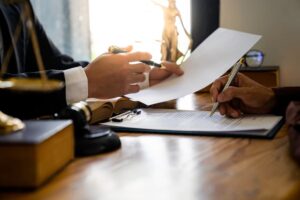 Lawyers consulting with business clients and reviewing statute of limitations documents.