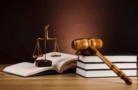 a gavel sitting on a pile of law books
