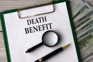 Learn about death benefits and financial aid with a focus on payouts, depicted by banknotes, a magnifying glass, and a pen.