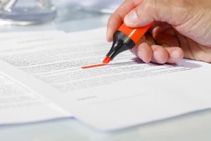 person highlighting medical injuries in paperwork