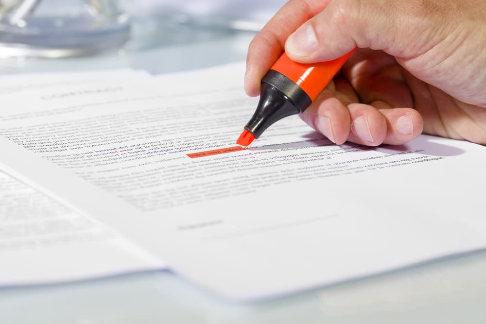 person highlighting medical injuries in paperwork