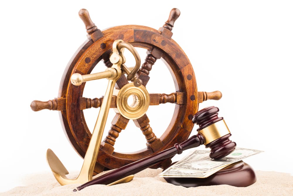 gavel with money and ship anchor