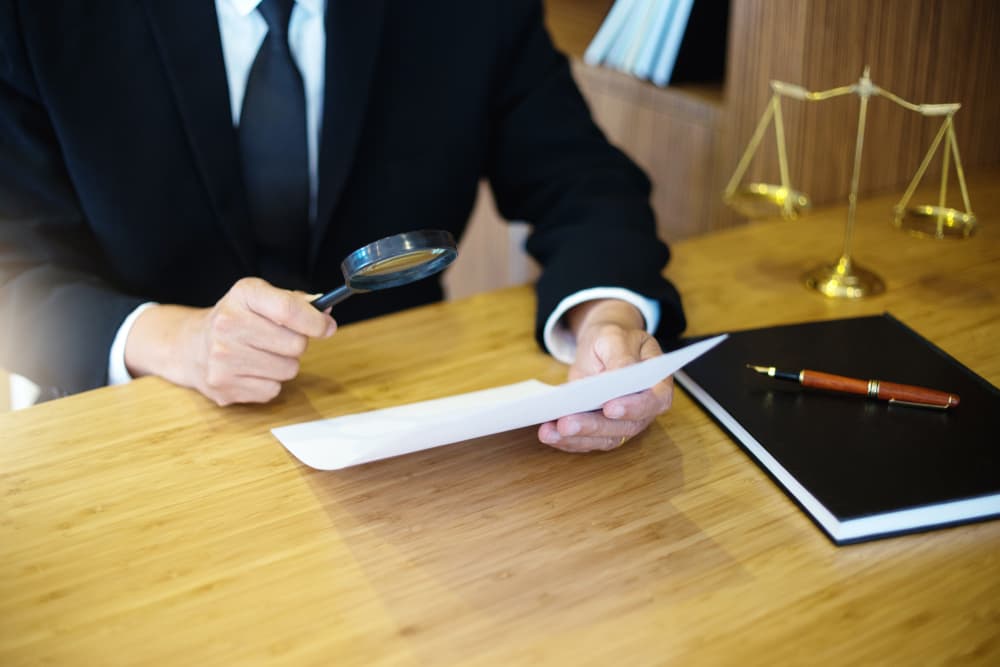 Judge lawyer read paper text by use Magnify glass concept law firm