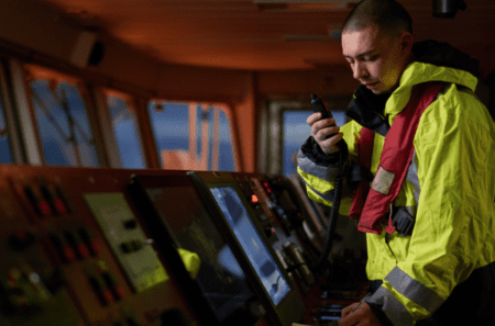 crew member on ship using vessel radio 