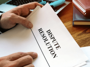 a man holding legal papers entitled dispute resolution.