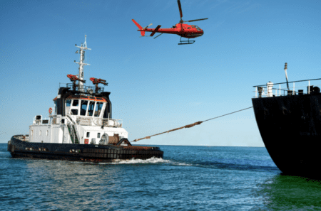 a vessel being pulled to shore after a maritime accident.