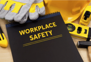 workplace safety manual surrounded by safety equipment.