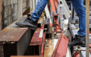 Worker in hazardous conditions stepping over broken steps